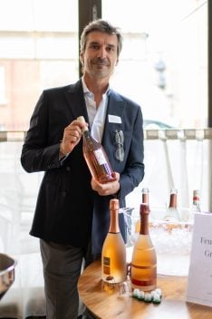 Andrea Fabiano holding a bottle of San Greg rosé